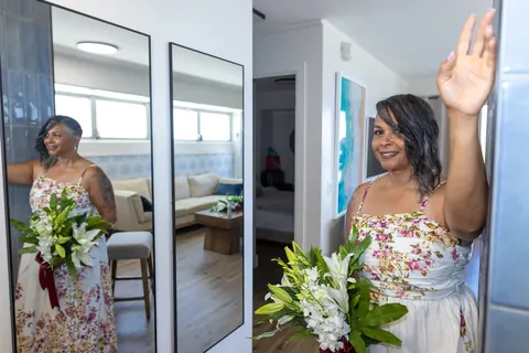 Jocelyn waving with her bouquet in the mirror