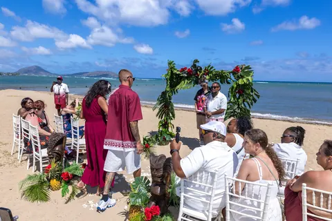 Wide view of the beach ceremony with the guests and the ocean