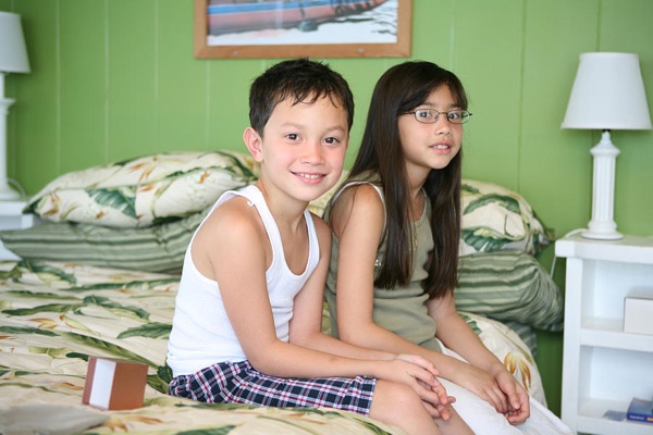Kids sitting on the bed