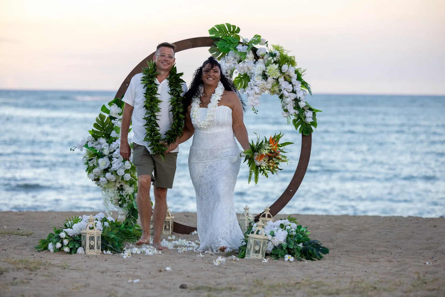The couple at the archway with the sea behind them