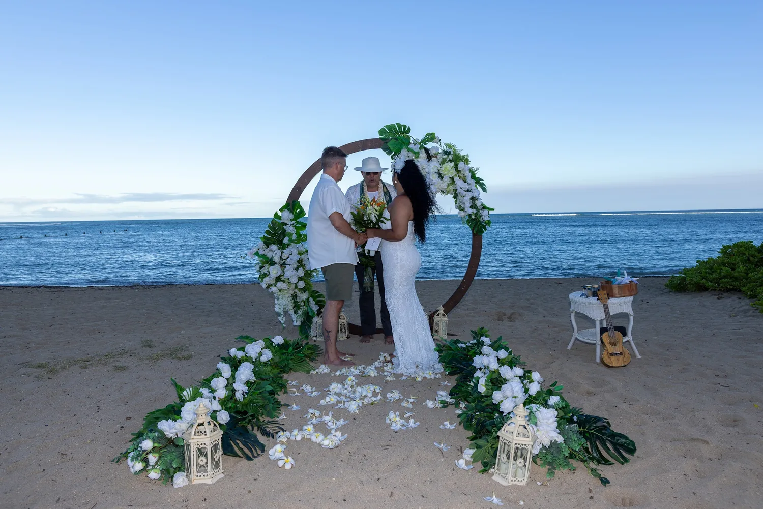 A wide view of the ceremony at the circle archway by the ocean