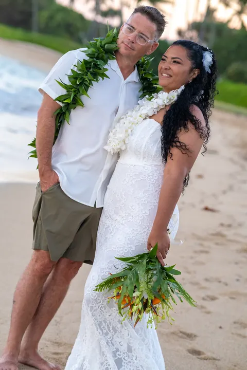 A beach portrait in their leis