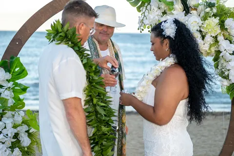 The officiant with John and Dianna at the archway