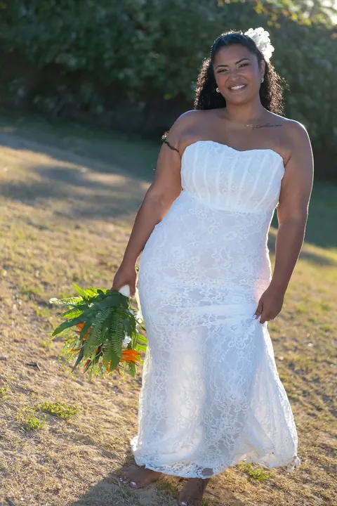 Dianna in a full-length white lace gown with her bouquet