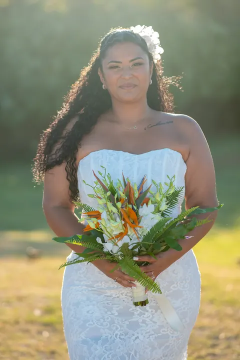 Dianna holding her bouquet in the golden evening light