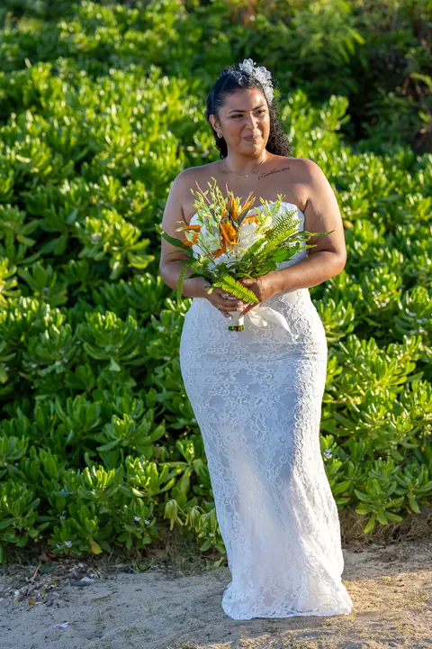 Dianna in white lace standing by the beach greenery