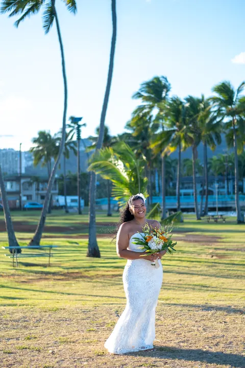 Dianna standing under the palm trees at Waialae Beach Park