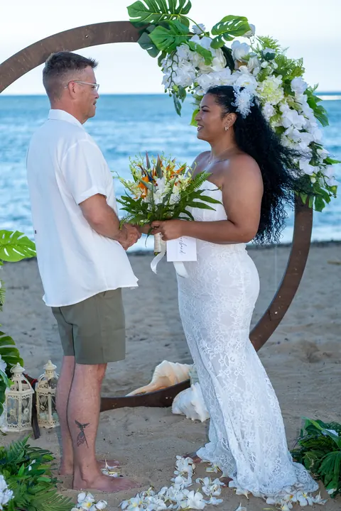 Dianna with her bouquet facing John at the archway