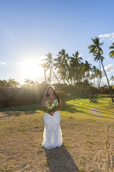 Dianna with the sun setting behind the palm trees