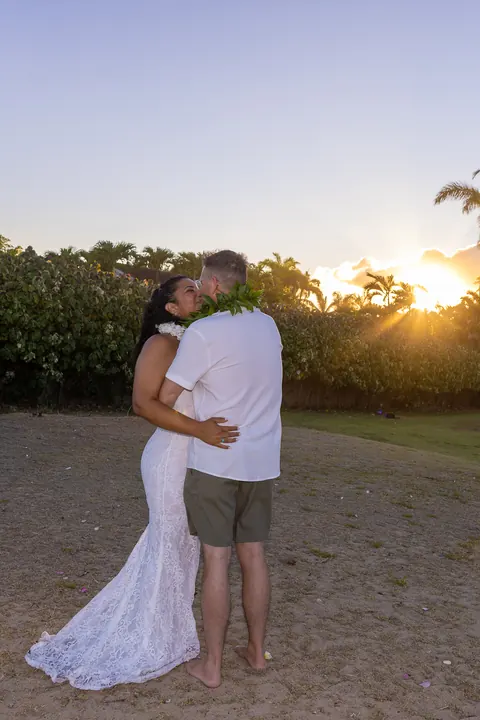 An embrace as the sun sets behind the trees