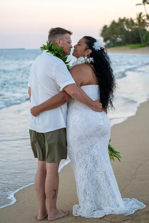 An embrace on the sand at sunset