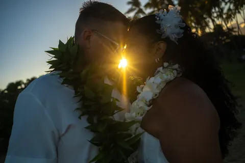 The sun peeking between them at sunset