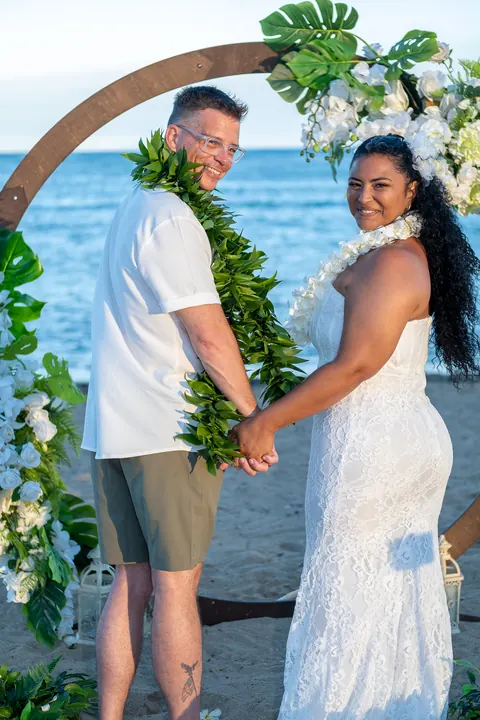 Hand in hand under the archway at the end of the ceremony