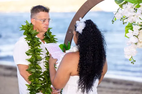 John reading his vows to Dianna