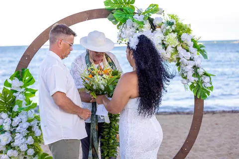 The officiant speaking to the couple at the archway