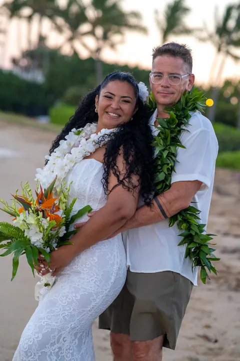 A portrait with the palm trees behind them