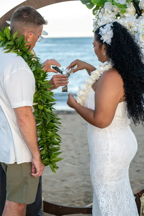Pouring black and white sand for their sand ceremony
