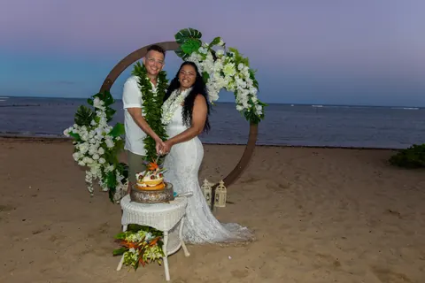Celebrating at the archway with the cake at dusk