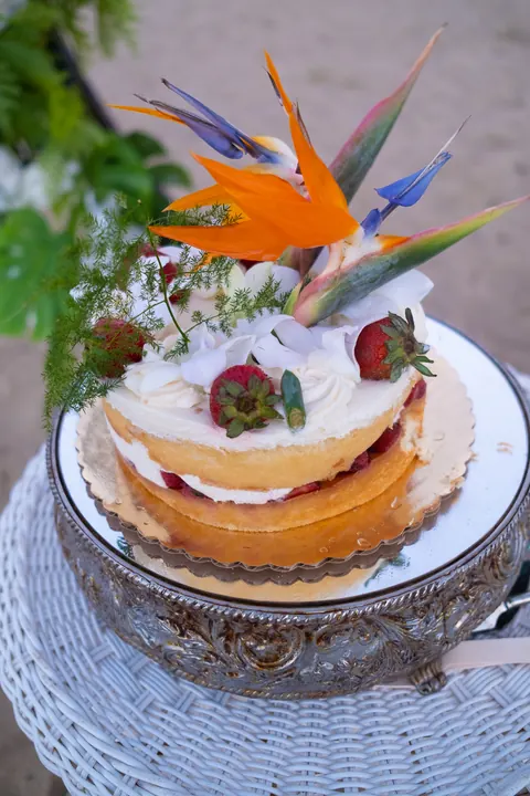 The wedding cake topped with bird of paradise