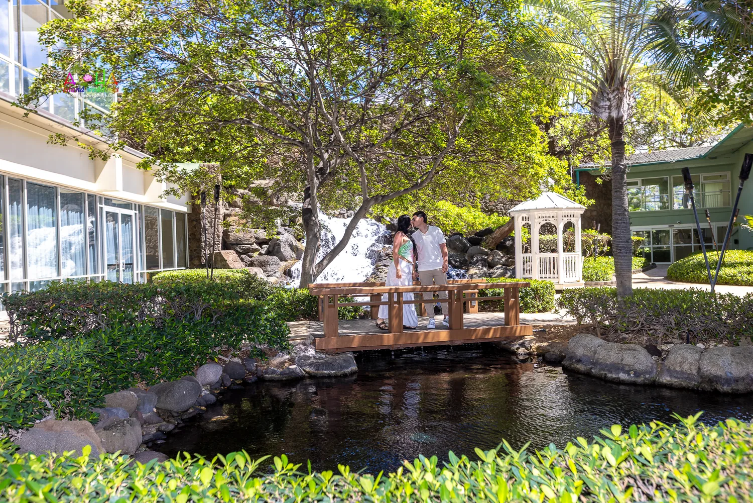 Newly engaged on the garden bridge by the waterfall