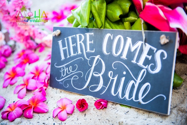 Hot pink plumeria with a Here Comes the Bride sign