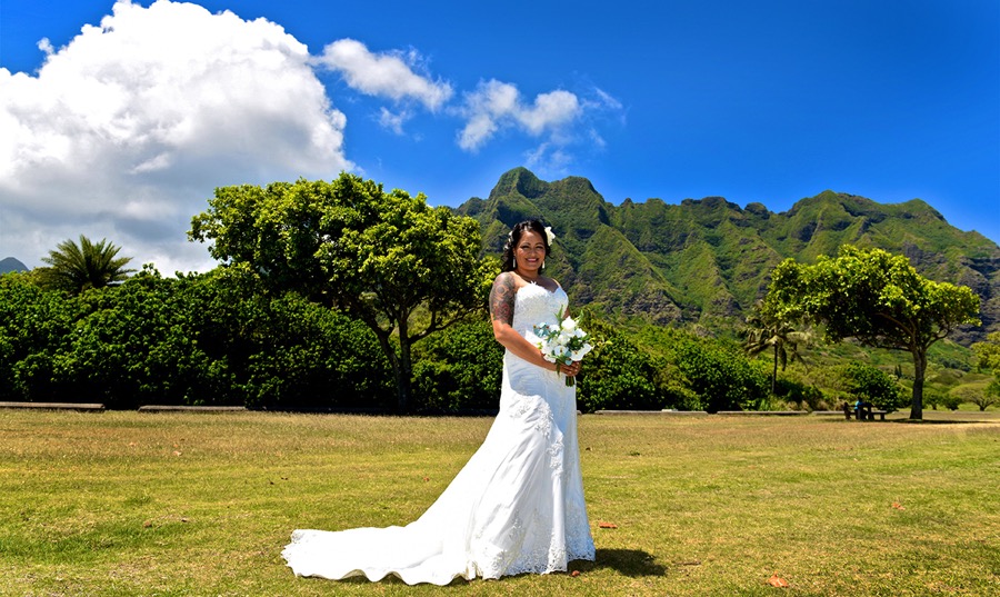 Bride with the Ko'olau mountains behind her after her Kualoa wedding