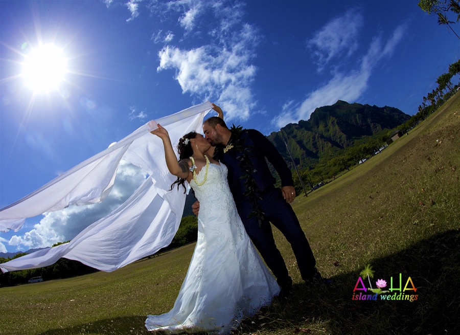 White chiffon blowing in the wind at a Kualoa Beach Park wedding
