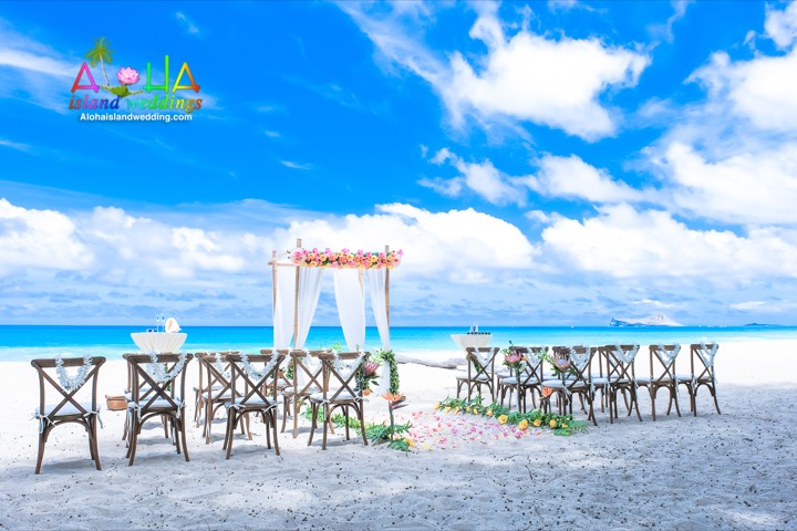 Cross back wooden chairs and the flower arch on Waimanalo beach