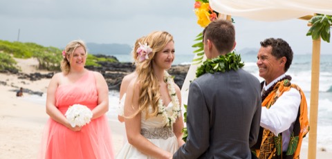 The minister shares the meaning of the flower leis at a Makapuu beach wedding