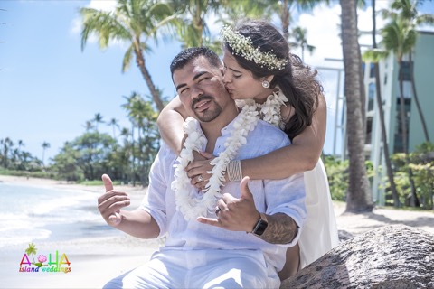 Bianca and Manuel in white orchid leis at their Waialae beach wedding