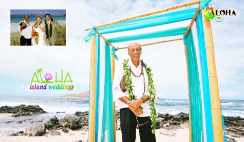Minister Fuller wearing a maile lei under a turquoise draped arch on Oahu