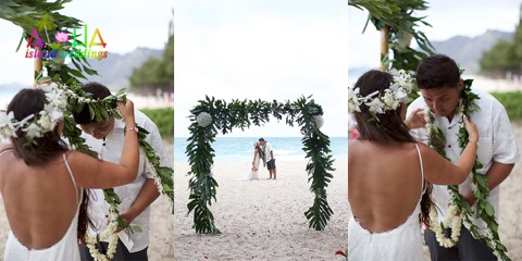 Casey places a maile lei on her husband under the flower arch at their Oahu wedding