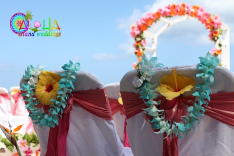 Turquoise and ocean blue orchid leis draped on the wedding chairs in Hawaii