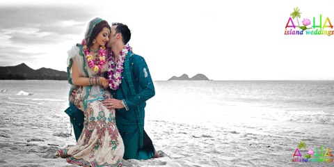 A couple in flower leis sharing a romantic moment by the ocean in soft black and white, Hawaii