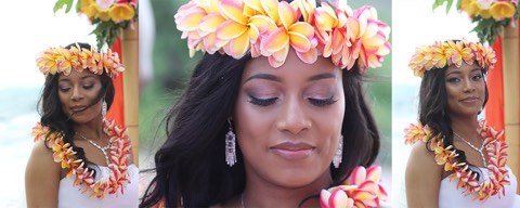 A bride in a rainbow plumeria head lei of orange, pink and yellow in Hawaii