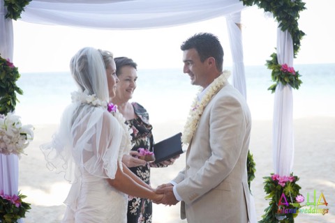 The minister smiles at the couple after their lei ceremony at a Hawaii wedding