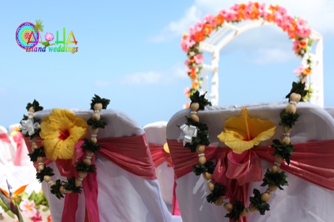 White kukui shell leis on the wedding chairs at a Hawaii beach wedding