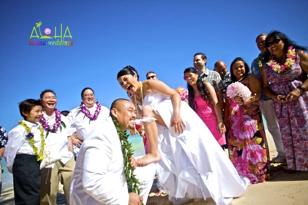 Biting the garter on the beach in Hawaii with Leling and family there