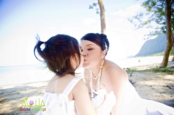 Kissing her daughter after their wedding Oahu beach
