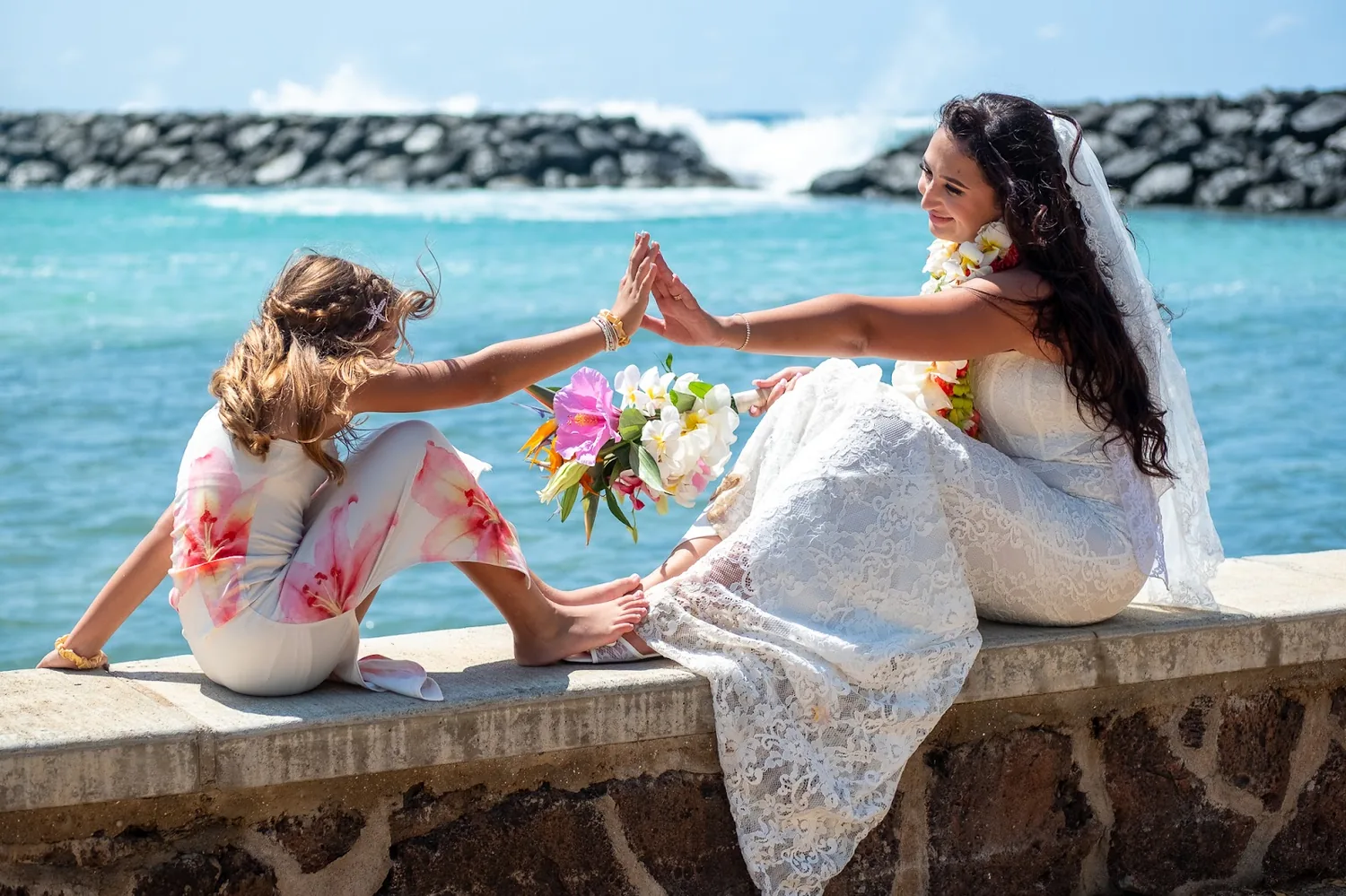 Mother and daughter playing on the seawall