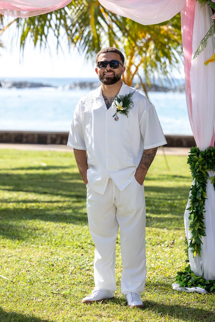 Mustafa in white with a white orchid boutonniere