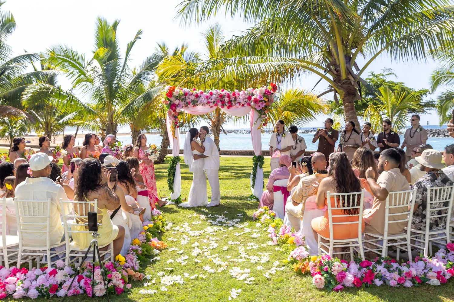 The bridal party arriving at the flower arch