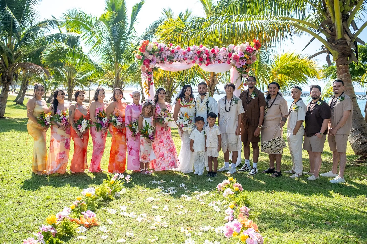 The bridal party lined up under the palms
