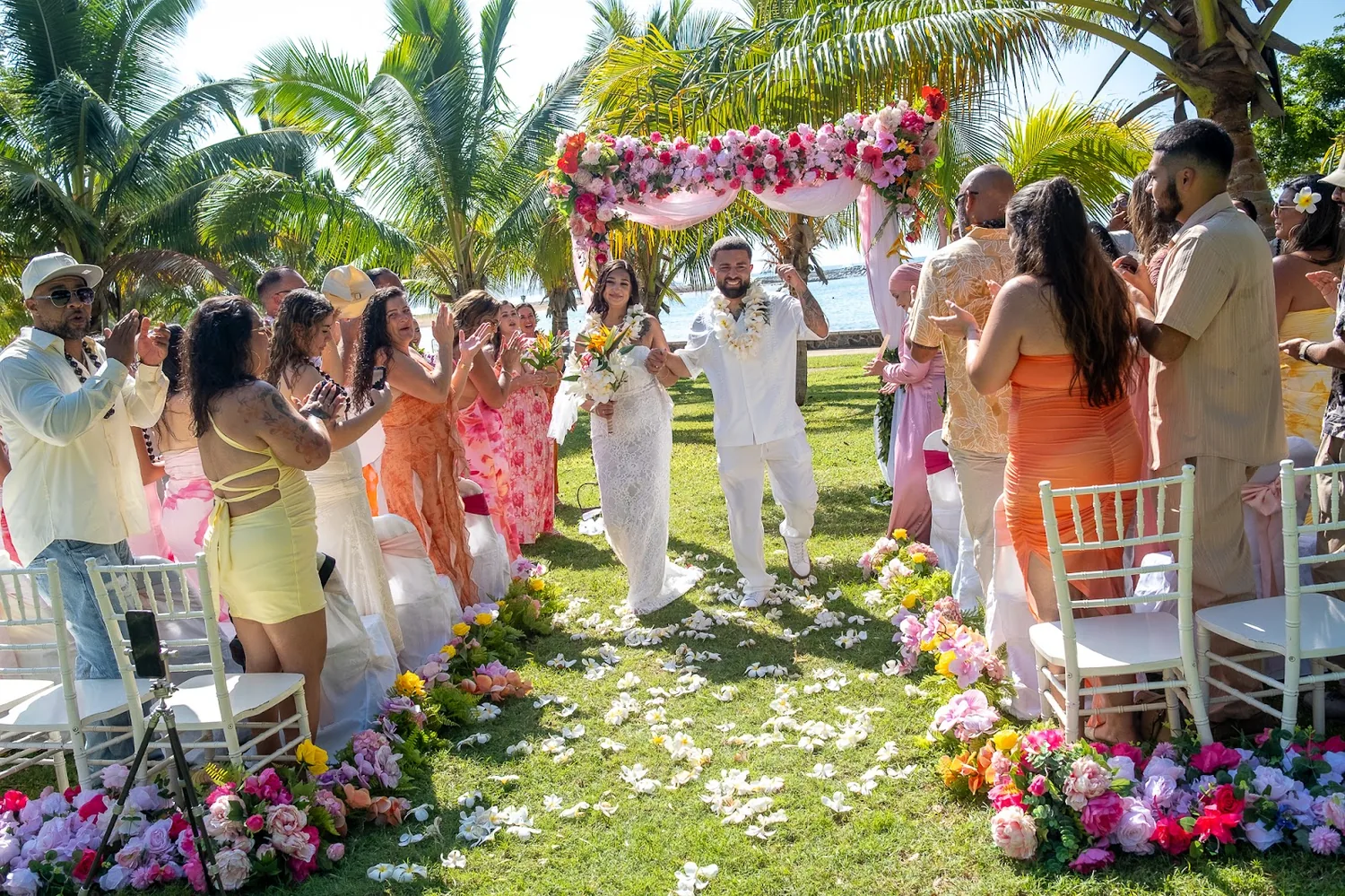 The ceremony under the palms with the bridal party beside them