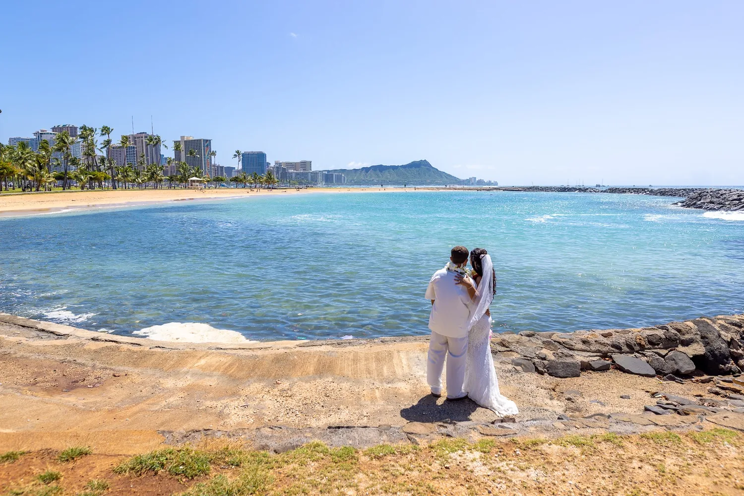 The couple on the beach with Diamond Head across the water