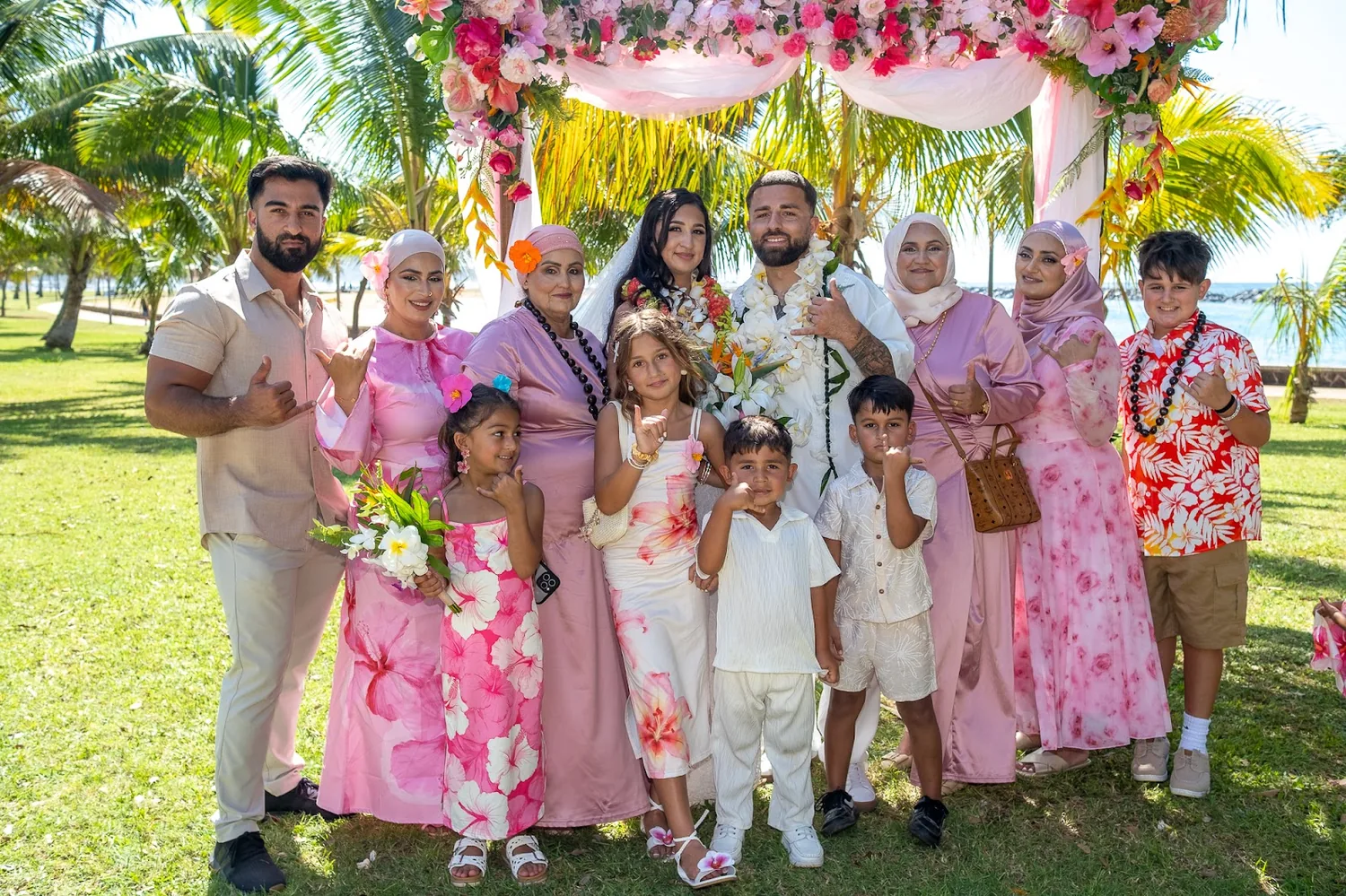 The couple with the bridesmaids in pink
