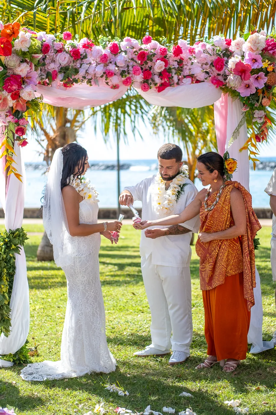 The officiant speaking to Lila and Mustafa
