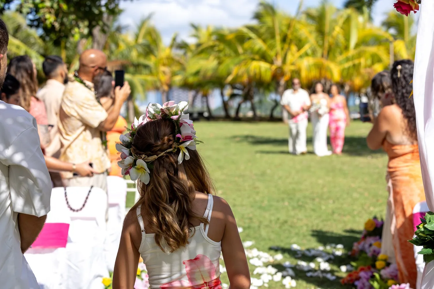 Their daughter, the flower girl, in her pink and white flower crown