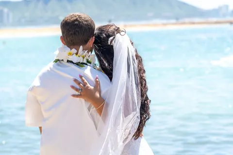 A hug with the ocean behind