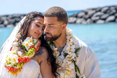 Lila and Mustafa cheek to cheek by the sea